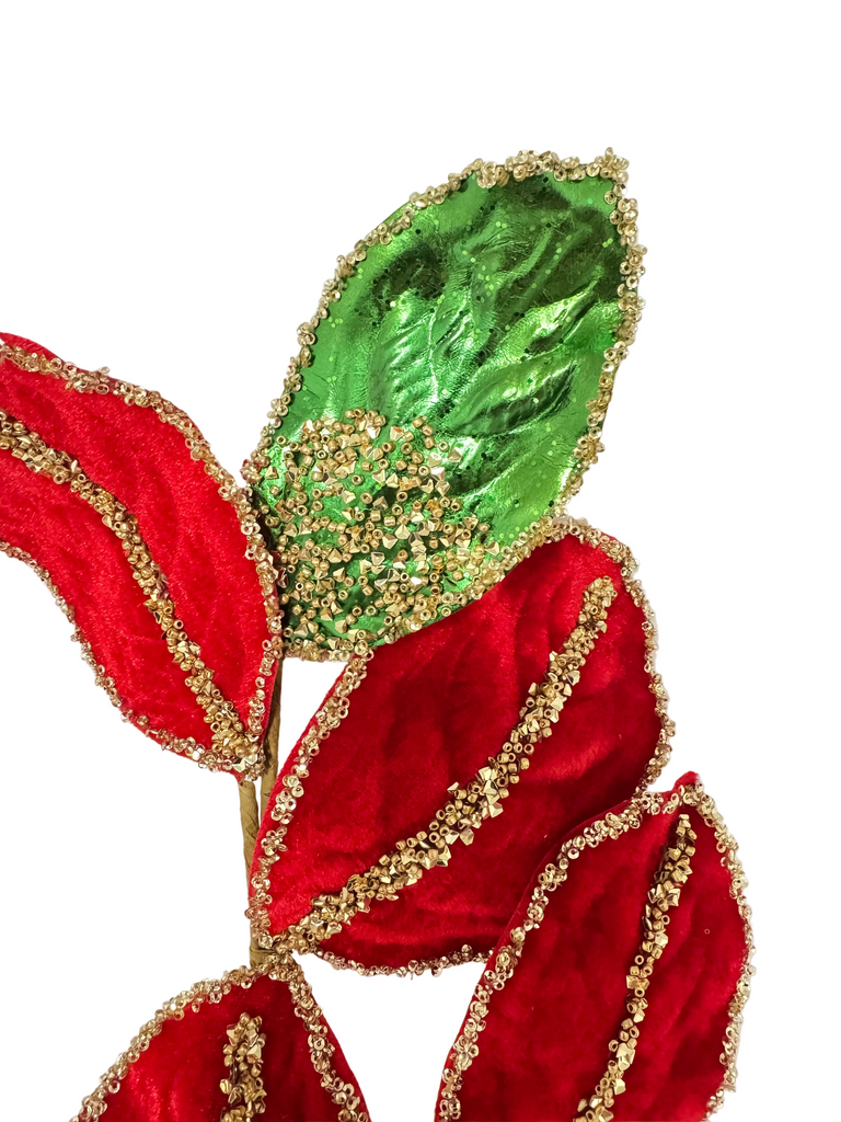 Decorative leaf with red, green, and gold colors on a white background